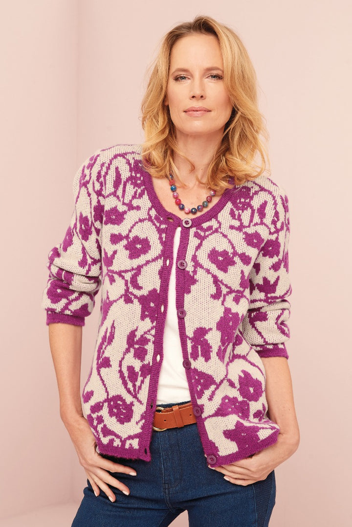 Lily Ella Collection women's purple floral-patterned knit cardigan, stylish casual wear, with white top, denim jeans, and beaded necklace.