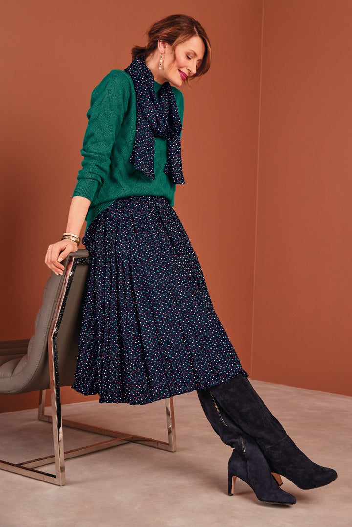 Lily Ella Collection elegant emerald green cardigan and navy polka dot midi skirt with black suede boots for trendy women's fashion.
