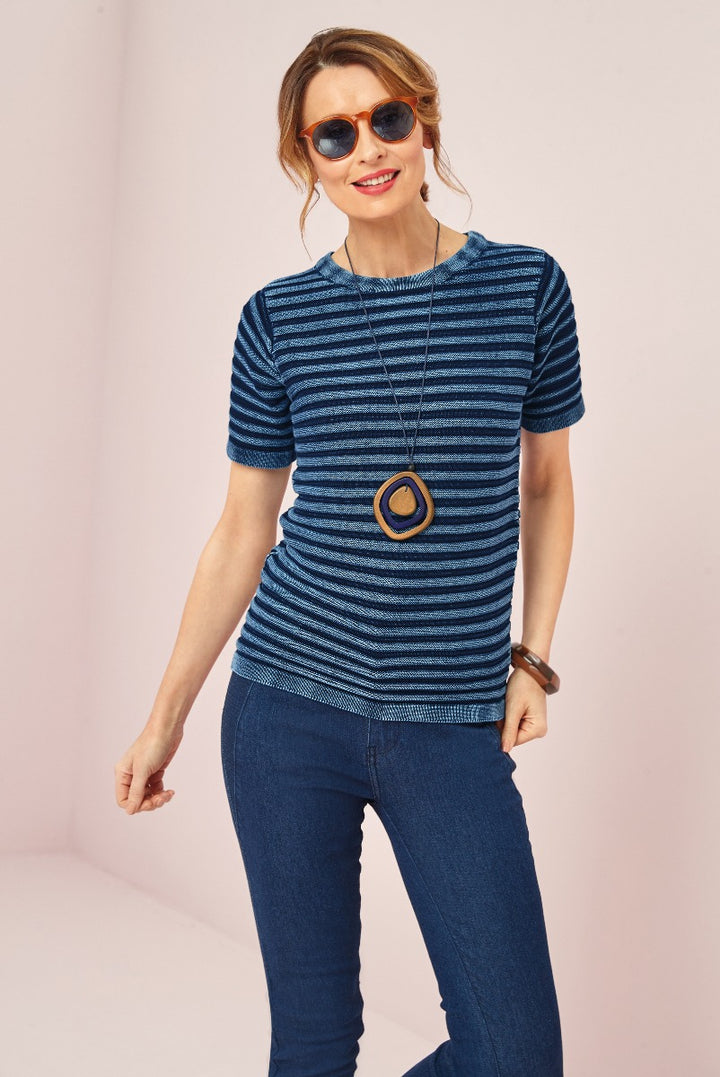 Lily Ella Collection chic blue striped knit top with casual jeans, accessorized with statement necklace and sunglasses on a female model.