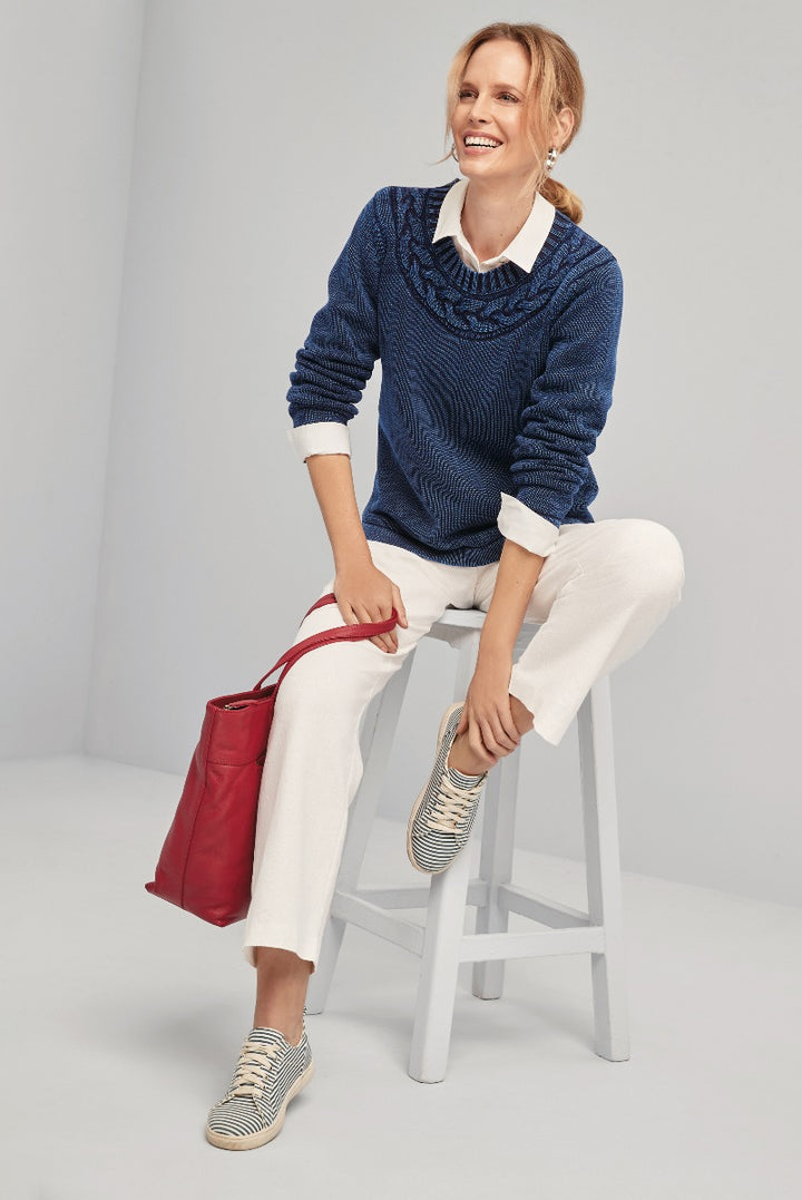 Lily Ella Collection navy blue cable knit jumper with white collar, casual white trousers, red tote bag and striped sneakers, women's stylish everyday outfit.