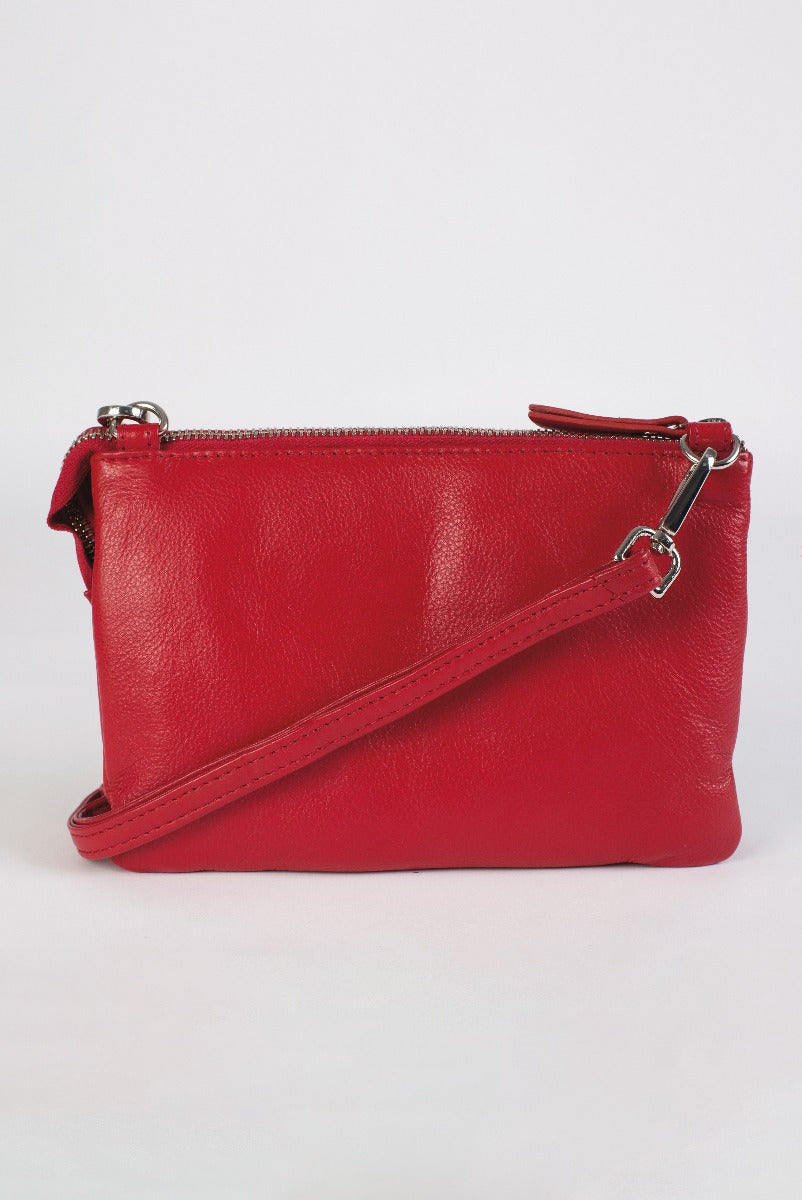 Lily Ella Collection red leather clutch bag with detachable strap on white background