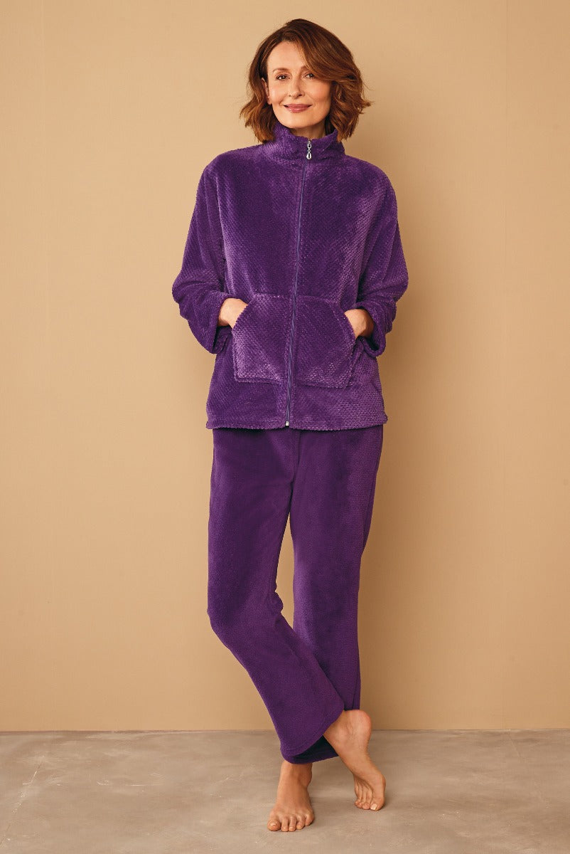 Lily Ella Collection women's purple fleece lounge set, comfortable zip-up jacket and matching pants, casual autumn winter fashion, cozy home attire, relaxed fit, mature model showcasing outfit.