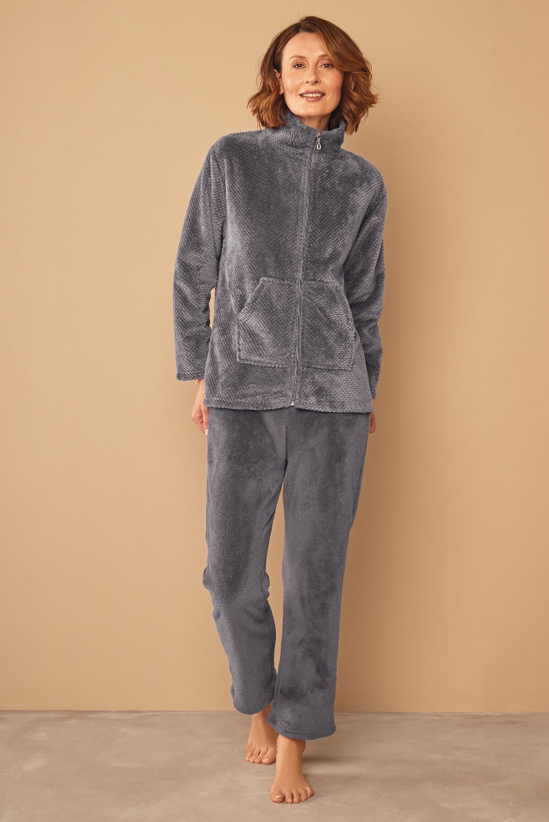 Lily Ella Collection woman smiling in cozy grey fleece loungewear set, featuring a zip-up jacket and matching pants, comfortable casual fashion, soft-textured outfit for relaxed home wear.