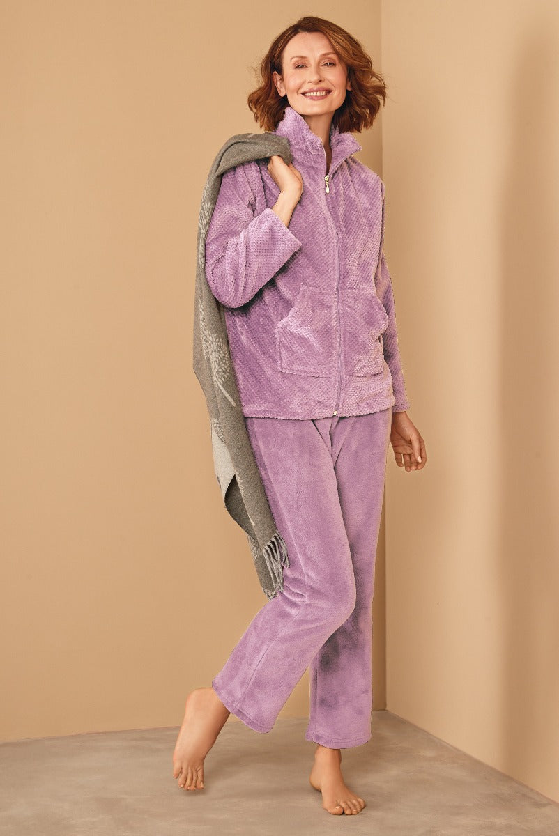 Lily Ella Collection women's loungewear in lavender, featuring plush zip-up jacket and comfortable pants with model holding a cozy grey fringed throw, elegant casual home attire.