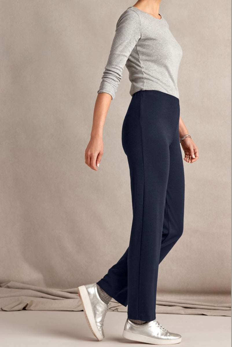 Lily Ella Collection elegant navy trousers styled with casual grey top and metallic silver sneakers for a sophisticated yet relaxed women's outfit.
