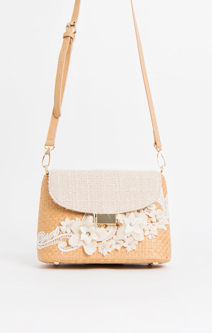 Lily Ella Collection beige woven shoulder bag with floral lace embellishments and adjustable strap.