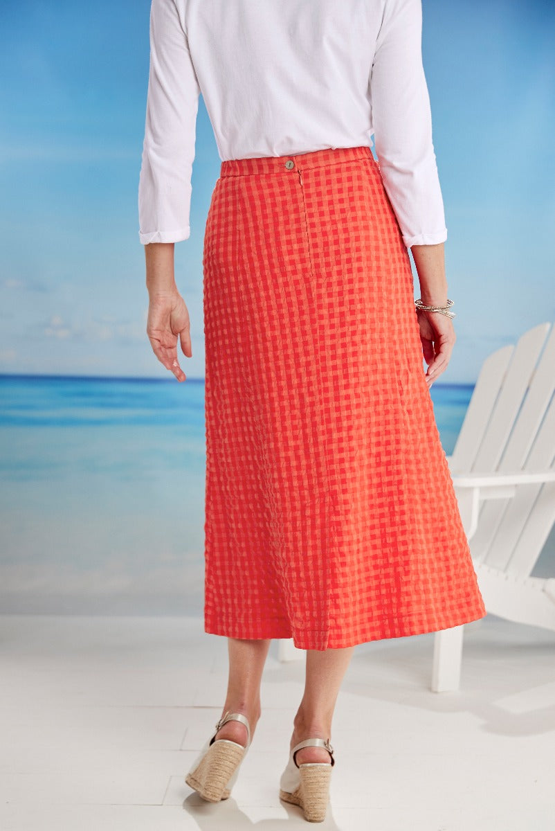 Lily Ella Collection orange check-pattern midi skirt, elegant women's summer fashion, paired with white blouse and espadrille wedge sandals.