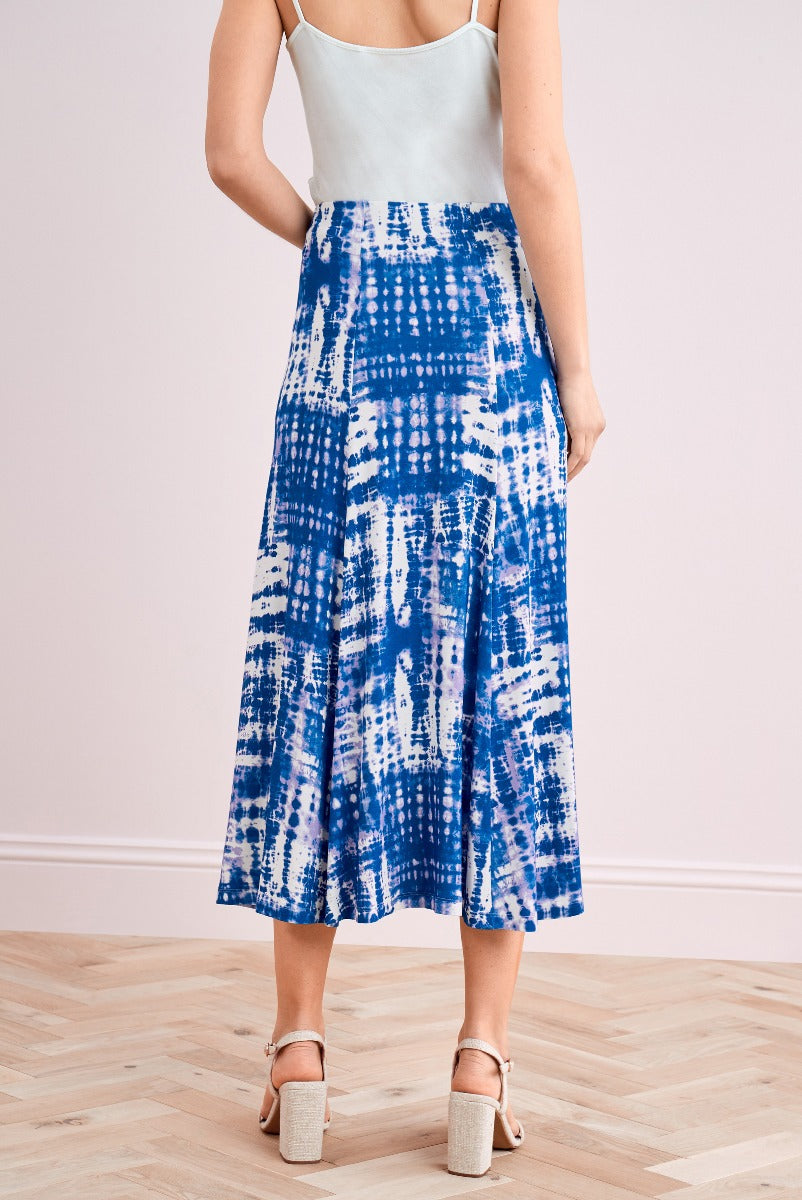 Lily Ella Collection blue and white tie-dye midi skirt paired with light green camisole and beige heeled sandals, stylish women's summer outfit.