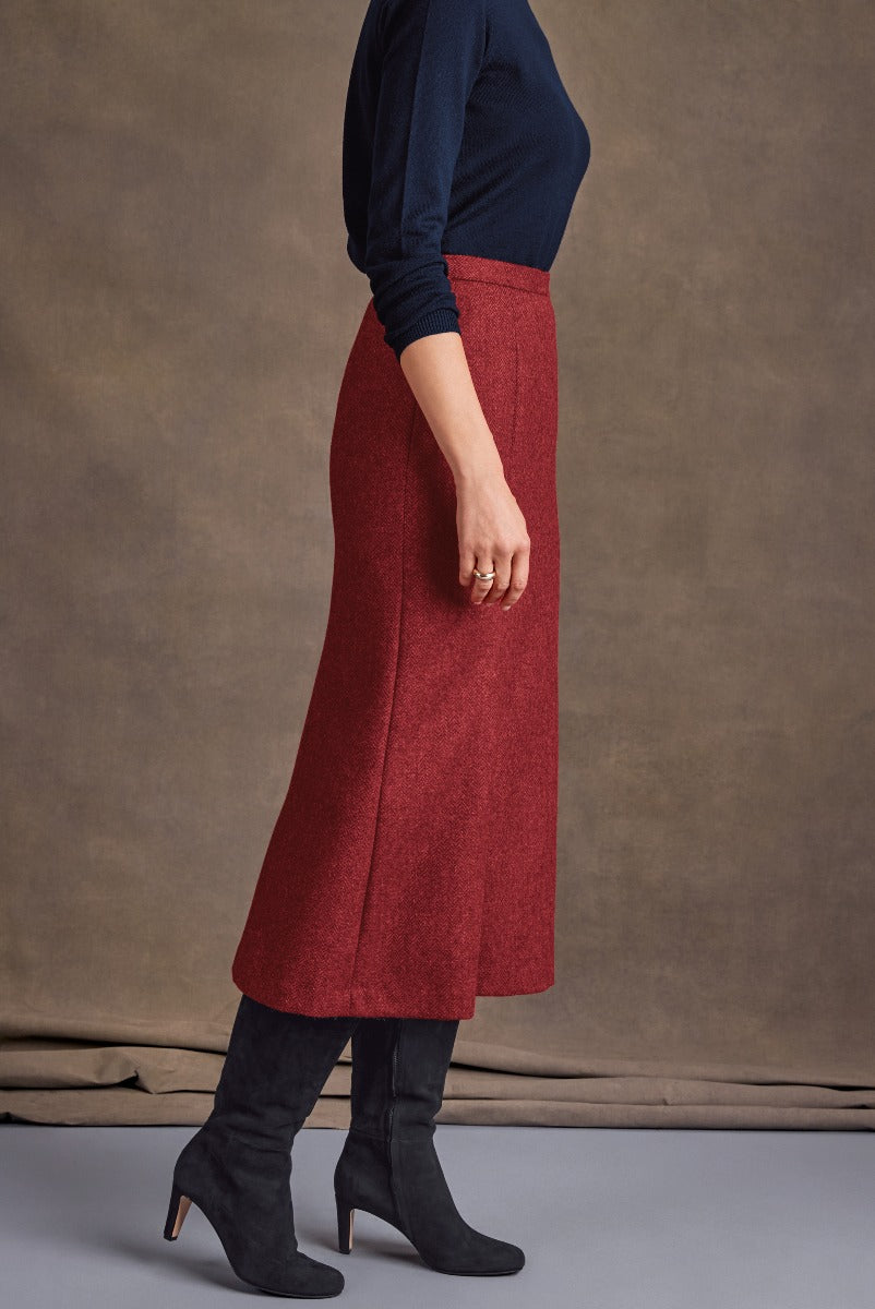 Lily Ella Collection elegant red A-line skirt paired with navy top and black suede boots, stylish winter outfit ideas for women.