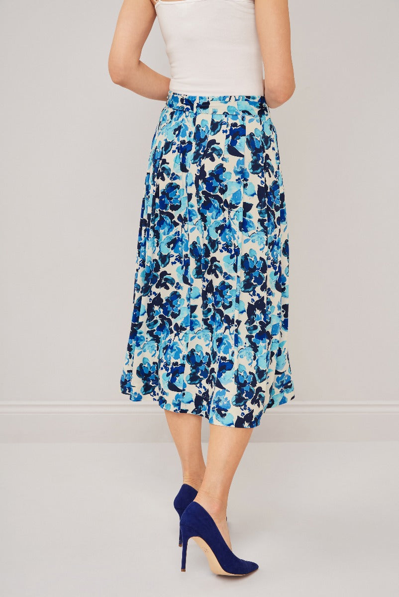 Lily Ella Collection blue floral midi skirt paired with white top and navy high heels