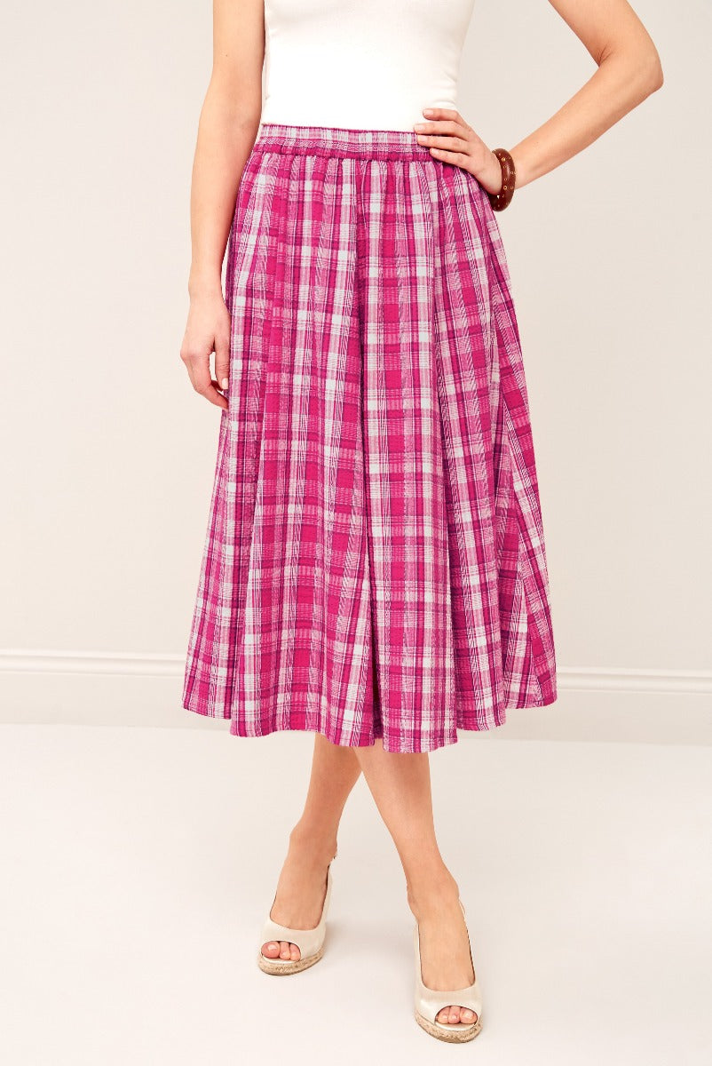 Lily Ella Collection pink plaid midi skirt, elegant A-line style, women's fashion clothing, paired with white heeled shoes