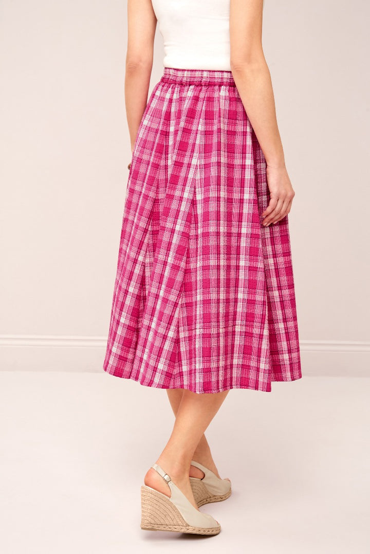 Lily Ella Collection pink checkered midi skirt for women, stylish A-line patterned skirt paired with wedge sandals, elegant and casual clothing for spring and summer.