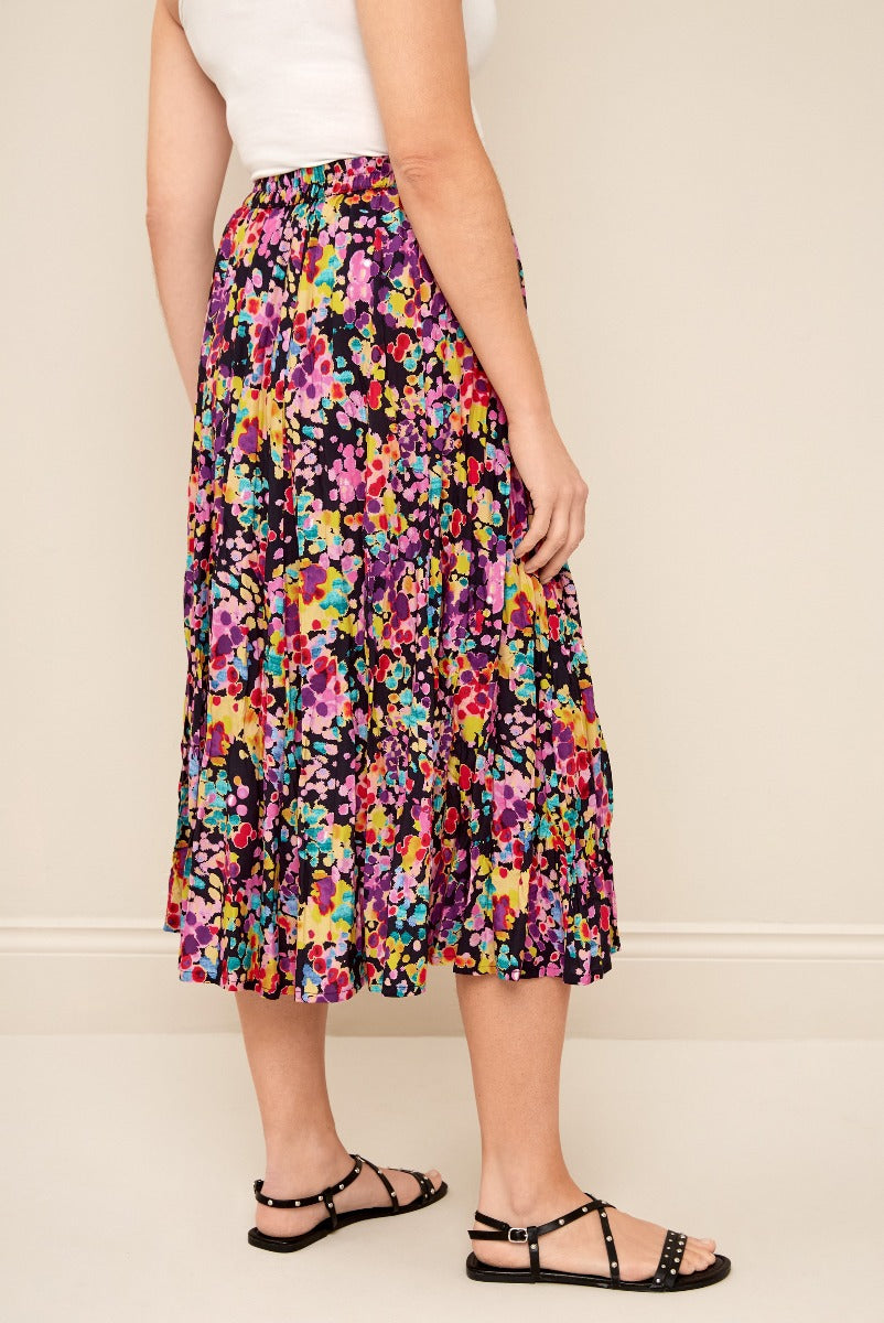 Lily Ella Collection colorful floral print midi skirt in purple with spring summer fashion women’s clothing and black strappy sandals