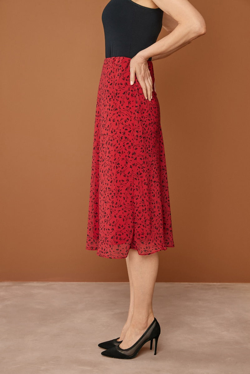 Lily Ella Collection elegant red floral mid-length skirt paired with black top and black heels for women.