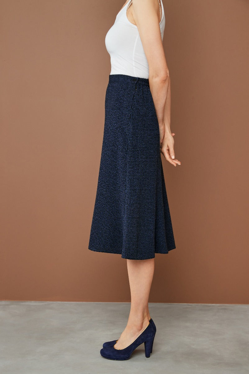 Lily Ella Collection navy textured midi skirt paired with white tank top and navy high heels, showcasing elegant casual style.