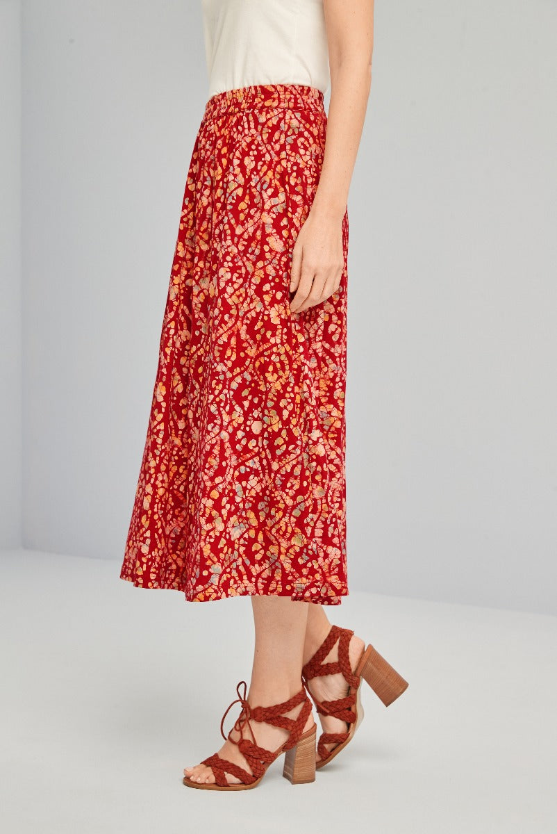 Lily Ella Collection red floral print midi skirt paired with brown strappy heels, women's bohemian style summer outfit.