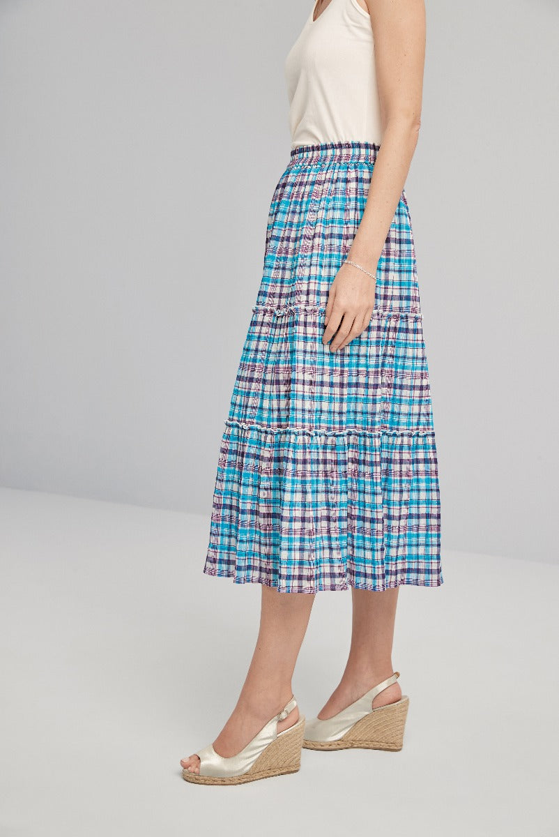 Lily Ella Collection blue plaid midi skirt with ruffle detail, stylish summer outfit, paired with cream wedge sandals