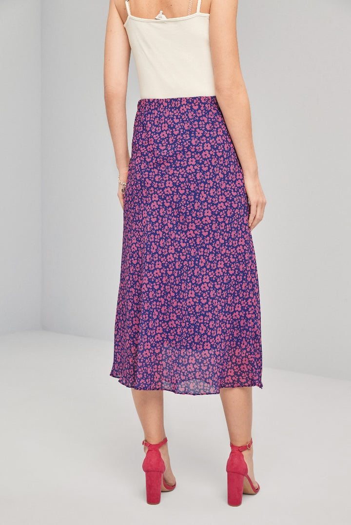 Lily Ella Collection purple floral pattern midi skirt paired with white camisole and red ankle strap heels for a chic spring look.