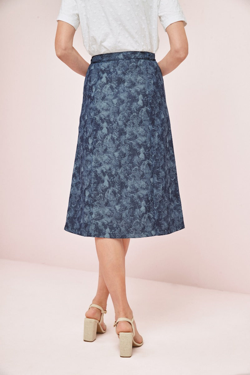 Lily Ella Collection elegant navy blue floral patterned A-line skirt paired with white blouse and chic beige block heels for a sophisticated women's fashion look