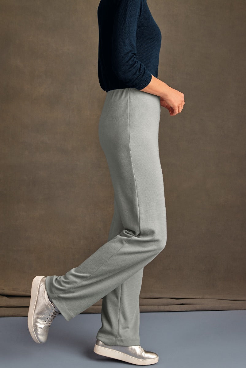 Lily Ella Collection stylish grey trousers for women, casual fit, comfortable design, paired with navy sweater and metallic silver sneakers.