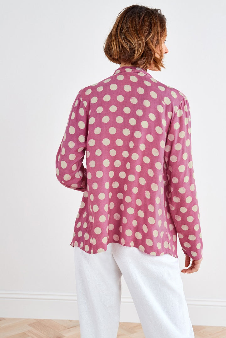 Lily Ella Collection pink polka dot shirt, stylish women's fashion, long-sleeved blouse rear view, elegant casual wear, paired with white trousers.