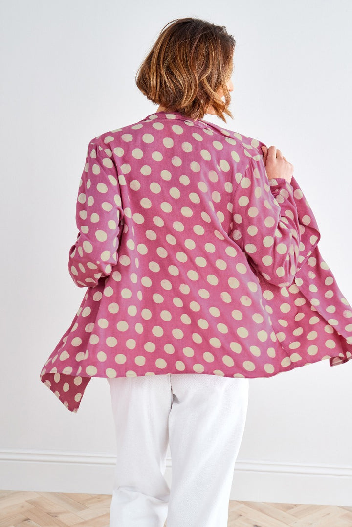 Lily Ella Collection pink polka dot blouse styled with white trousers, fashionable women's apparel, rear view of stylish polka dot top, elegant casual wear for ladies, vibrant color combination