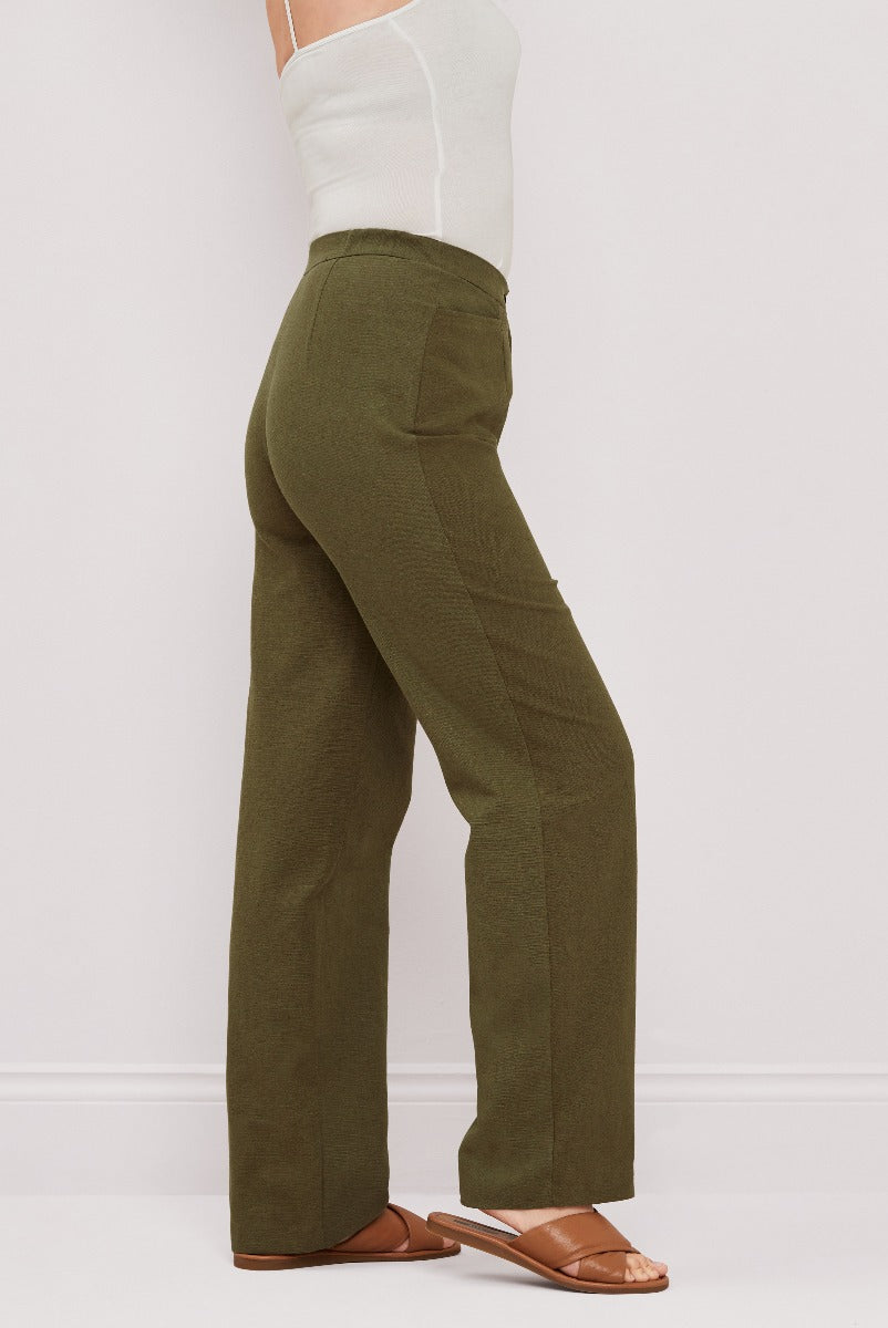 Lily Ella Collection olive green wide-leg trousers, stylish women's formal wear, elegant high-waisted pants for office or casual chic, paired with white top and brown sandals.