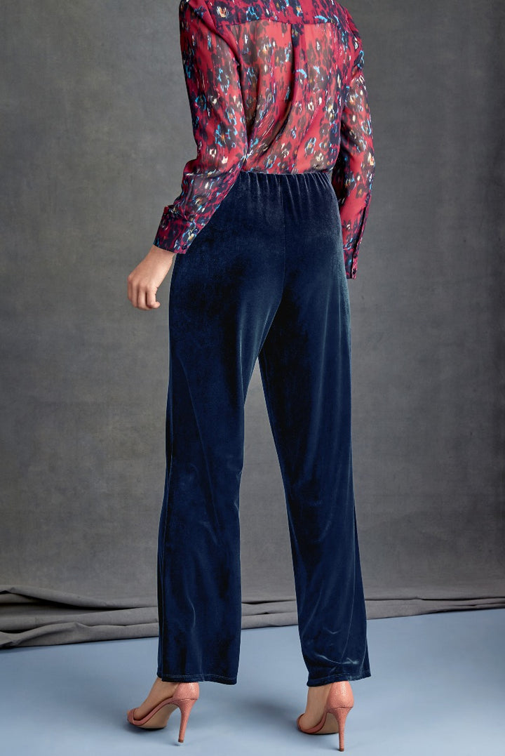 Lily Ella Collection elegant navy blue velvet trousers paired with a red floral print blouse, women's high-end fashion, side view.