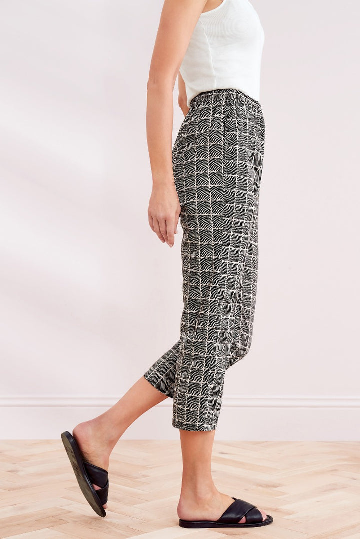 Lily Ella Collection women's chic black and white patterned culottes with a comfortable fit, paired with a casual white tank top and black slides, perfect for a stylish summer outfit.