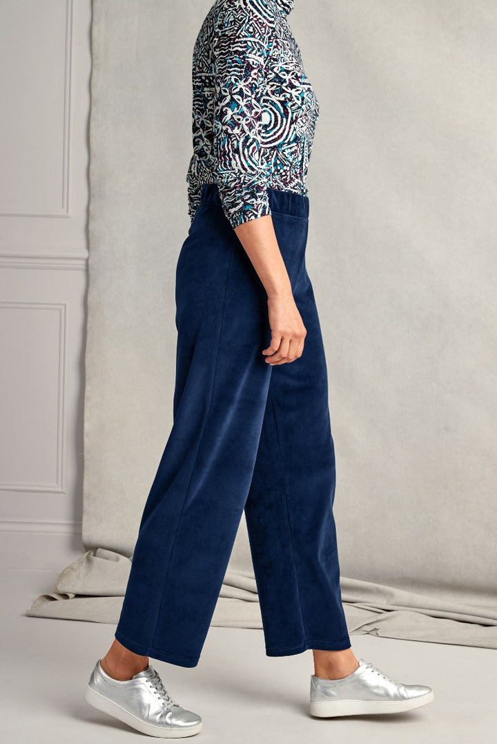 Lily Ella Collection navy blue culottes paired with a patterned top and silver sneakers, showcasing casual yet stylish women's fashion.