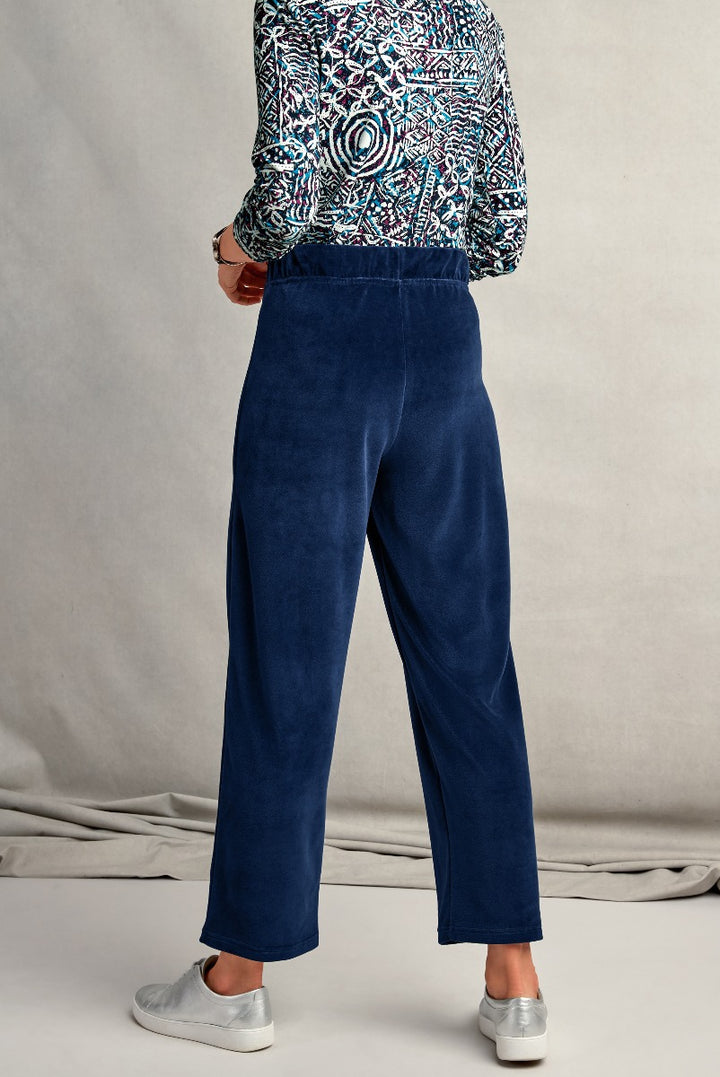 Lily Ella Collection navy blue velvet trousers with patterned top and silver sneakers for women.