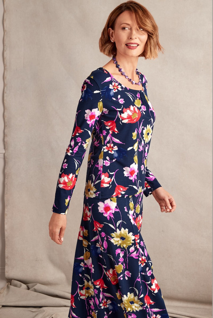 Lily Ella Collection floral dress, navy blue with vibrant multicolor print, elegant style, three-quarter sleeve, woman modeling trendy outfit for spring season.