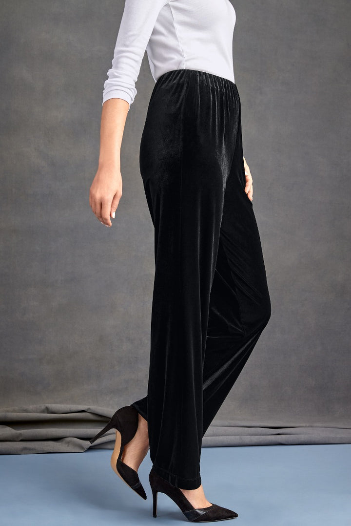 Lily Ella Collection black velvet pants, elegant women's trousers, side view, paired with white top and black heels.