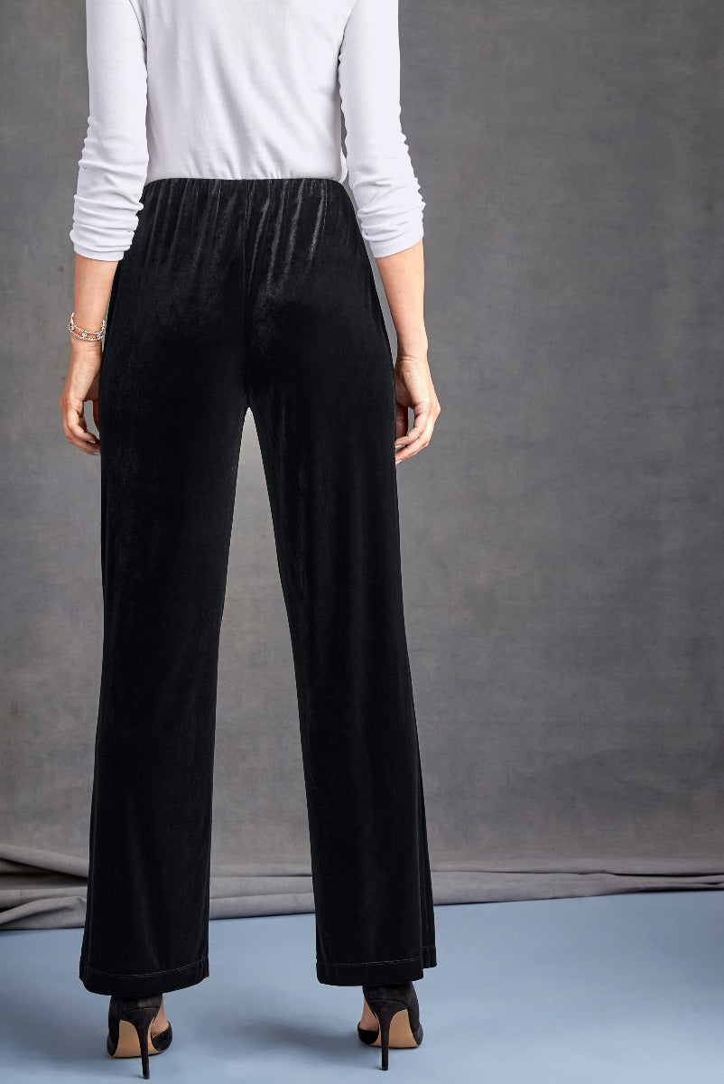 Lily Ella Collection elegant black velvet wide-leg trousers, stylish women's high-waist pants for formal or evening wear, paired with white top and black heels.