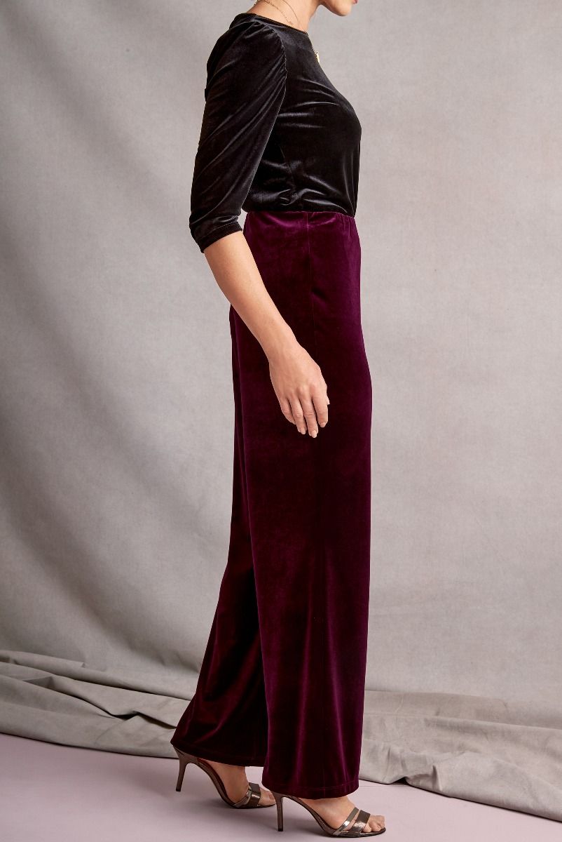 Lily Ella Collection elegant maroon velvet trousers paired with a black velvet top, showcasing a classic and sophisticated style for women.