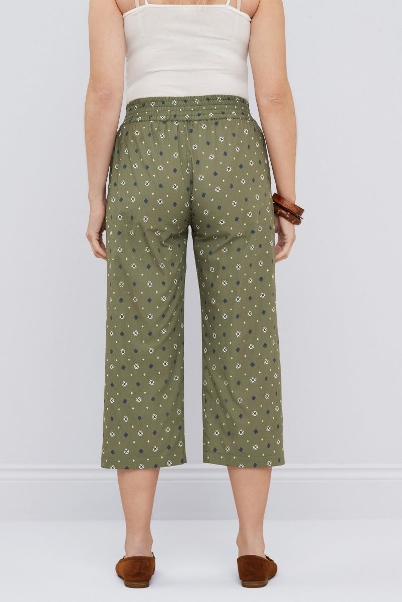 Lily Ella Collection women's olive green patterned culottes with drawstring and pockets, paired with white tank top and brown moccasins.