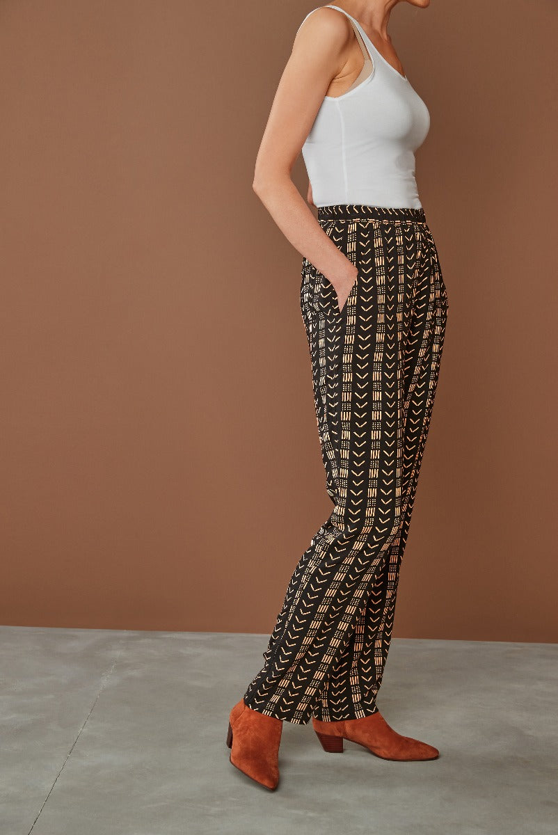 Lily Ella Collection women's fashion, model wearing black and cream patterned palazzo trousers with white tank top and terracotta boots, stylish comfortable outfit for casual or office wear
