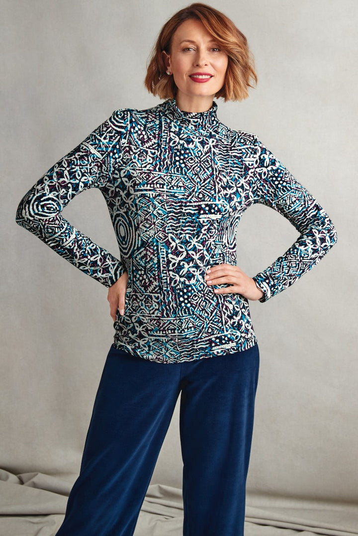 Lily Ella Collection stylish high-neck patterned top in blue and white, paired with navy blue trousers, elegant women's fashion.
