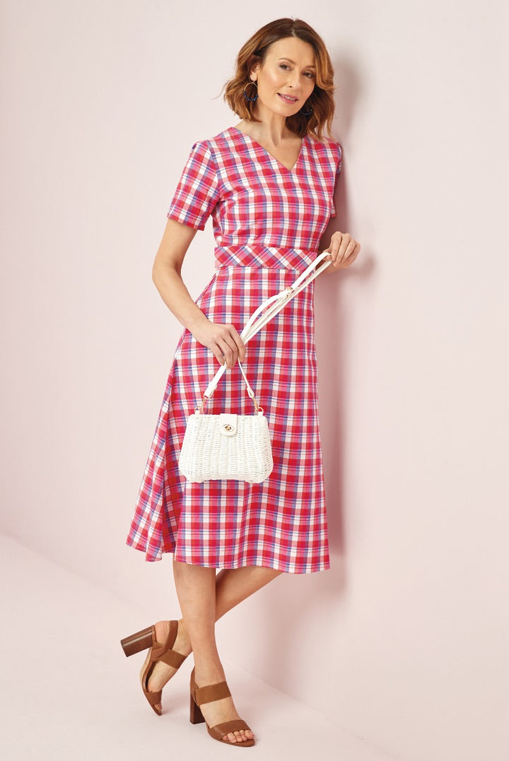 Lily Ella Collection stylish pink and blue checked summer dress paired with white woven handbag and brown strappy heels for women.