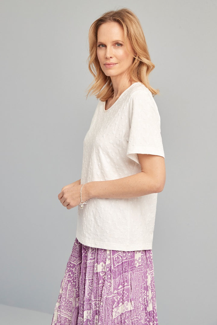 Lily Ella Collection white textured short sleeve top paired with purple patterned bohemian skirt, stylish women's casual wear.