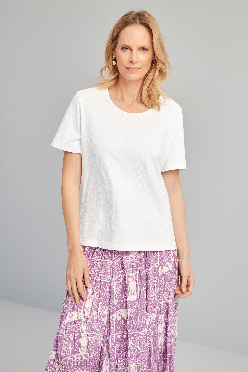 Lily Ella Collection white textured t-shirt paired with bohemian style purple patterned skirt, women's casual summer fashion.
