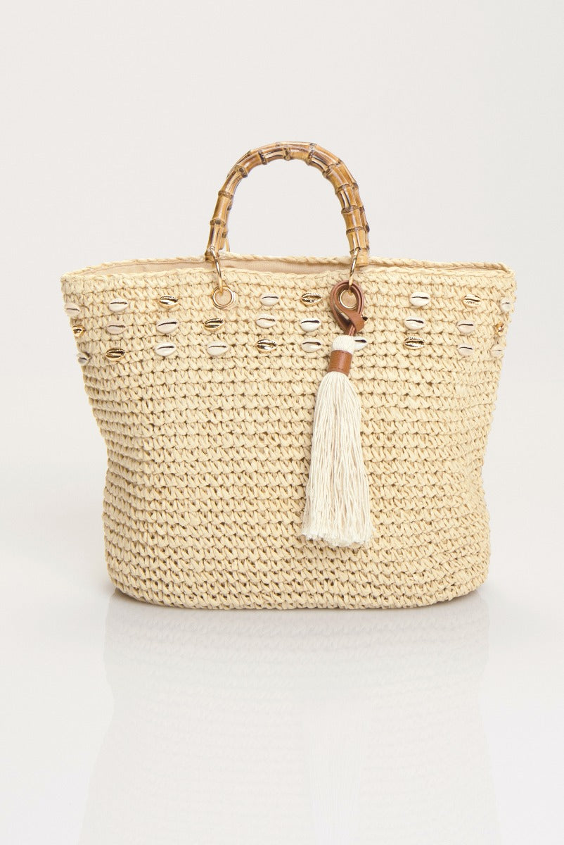 Lily Ella Collection beige straw tote bag with bamboo handles and white tassel accessory