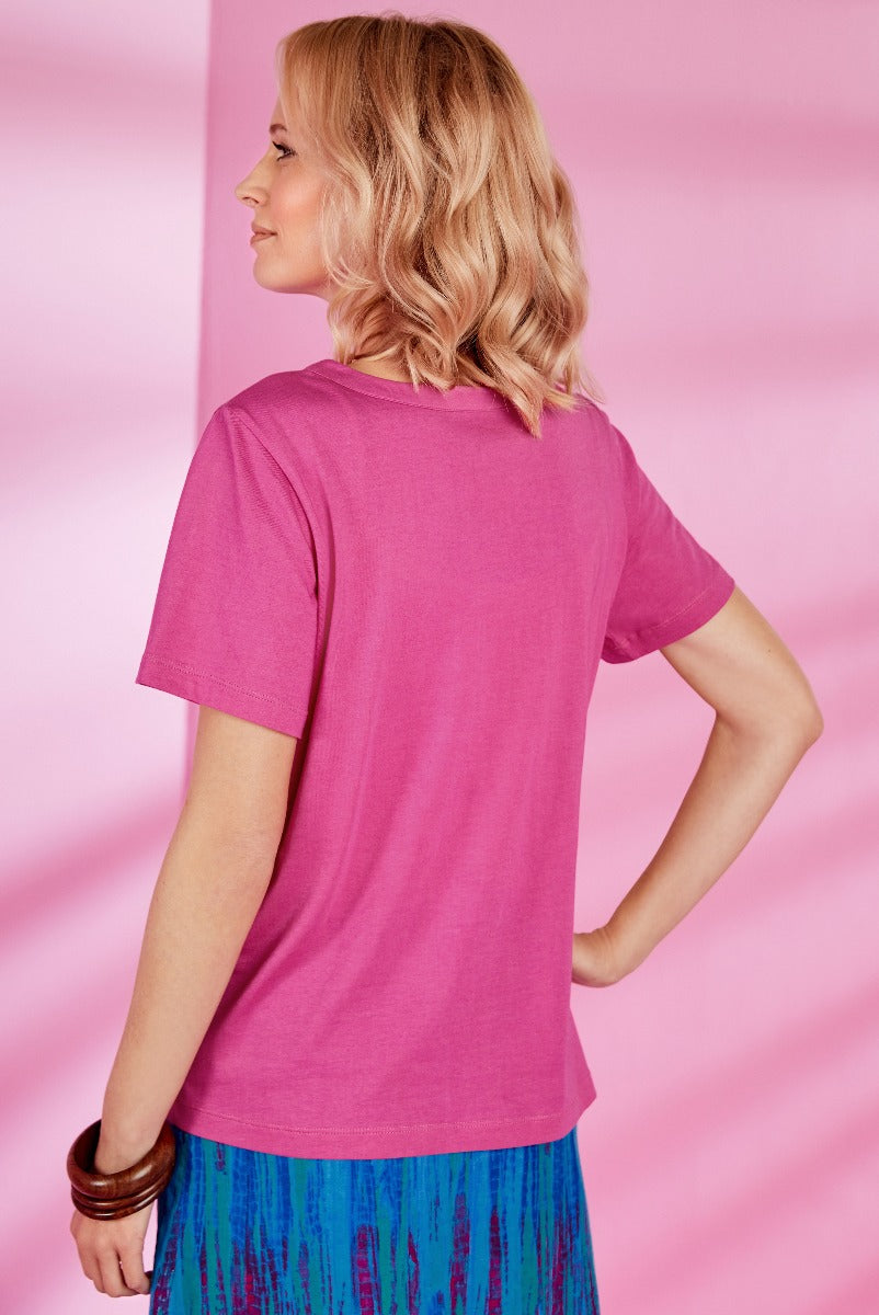 Lily Ella Collection fuchsia pink casual t-shirt, women's relaxed fit top with short sleeves, paired with a vibrant blue patterned skirt, fashion-forward apparel for spring/summer season.