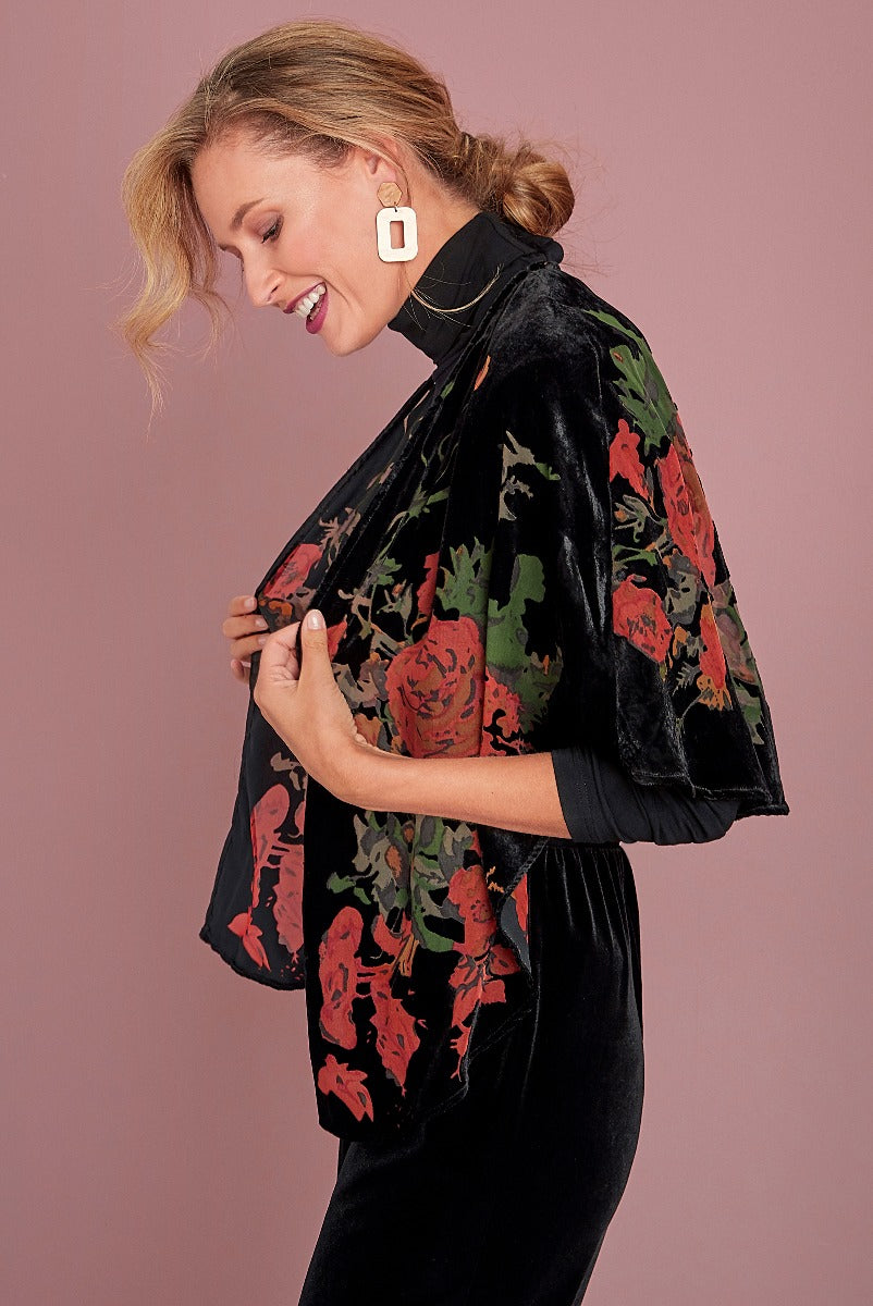 Lily Ella Collection elegant black velvet dress with floral patterned shawl, stylish women's evening wear, red and green floral accessory, sophisticated attire with geometric white earrings