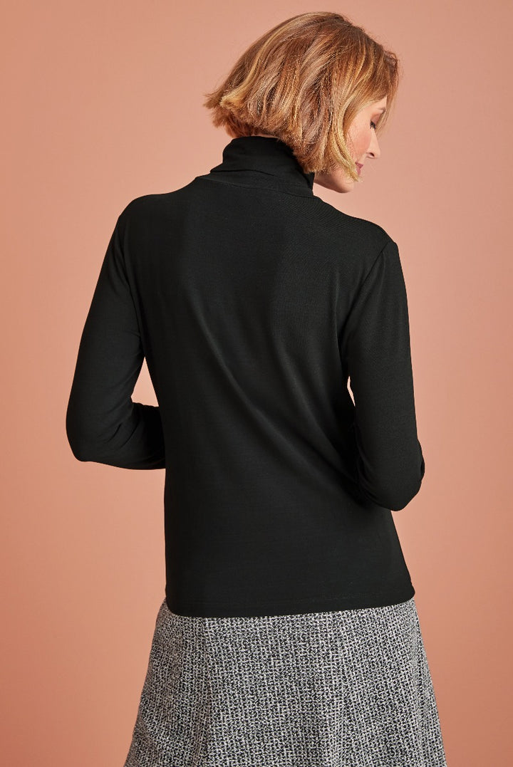 Lily Ella Collection black turtleneck top rear view paired with patterned skirt, elegant women's fashion and style.