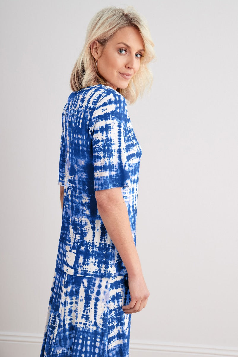 Lily Ella Collection blue tie-dye pattern dress with short sleeves and knee-length design, stylish women's casual wear, model showcasing side view.