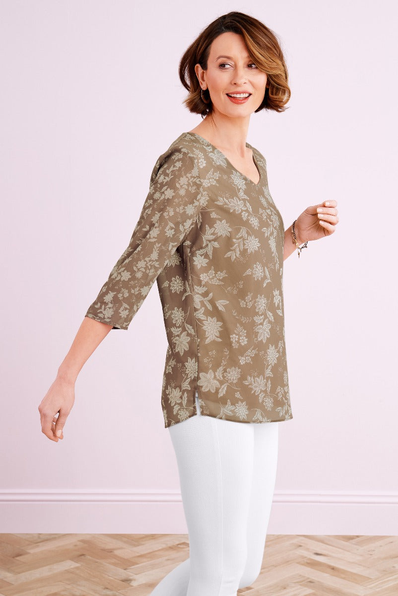 Lily Ella Collection olive green floral print tunic top for women, stylish 3/4 sleeve design, comfortable casual wear, paired with white leggings.