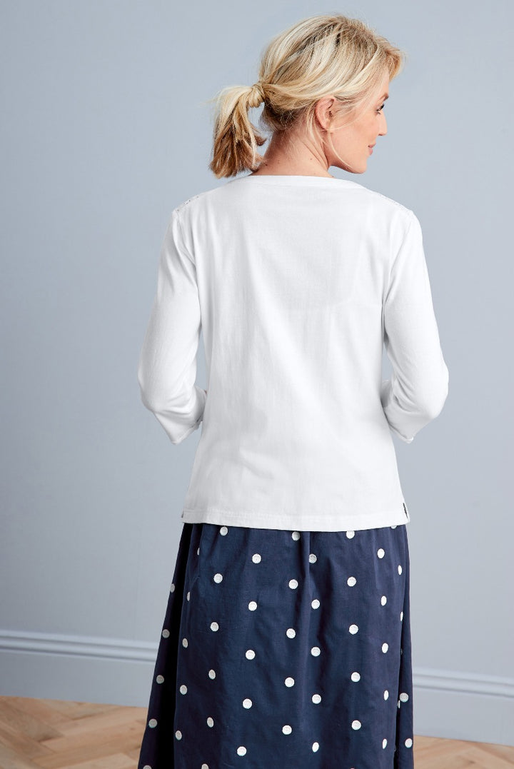 Lily Ella Collection elegant white blouse three-quarter sleeves with navy polka dot skirt women's fashion rear view.