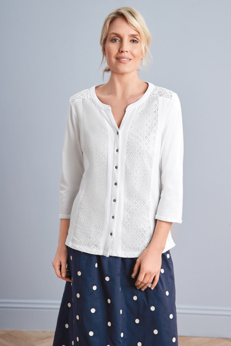 Lily Ella Collection elegant white lace detail blouse paired with a navy polka-dot skirt, featuring a modern but classic design for versatile women's fashion.