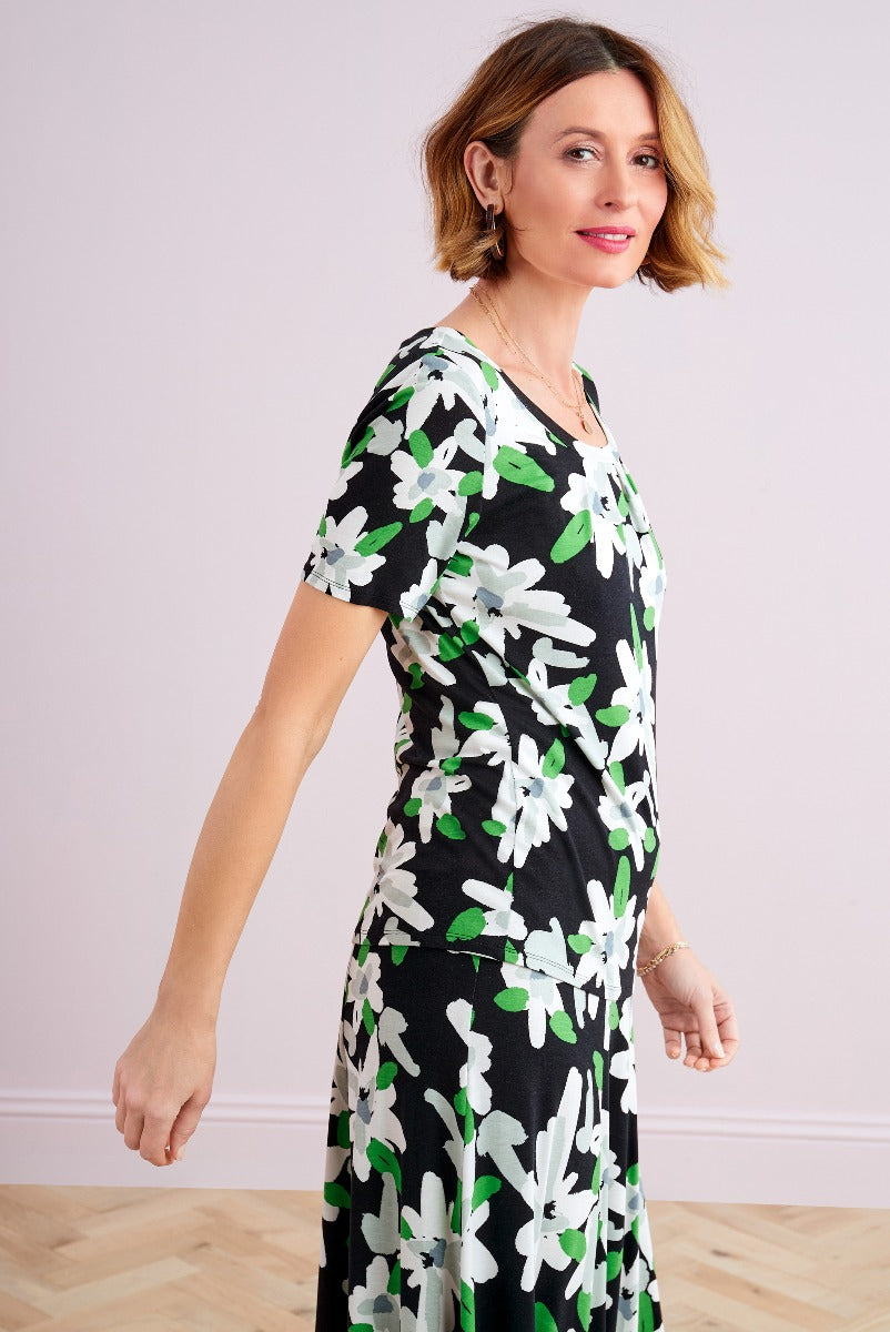 Lily Ella Collection floral dress, woman wearing black with green and white flower patterned midi dress, fashionable spring clothing, elegant casual daywear